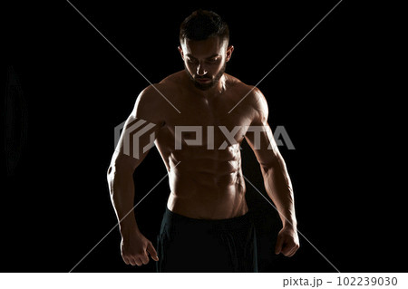 Muscular bodybuilder guy doing posing 102239030