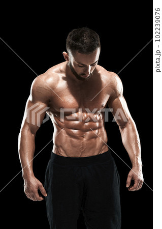 Muscular bodybuilder guy doing posing Muscular bodybuilder guy doing posing 102239076