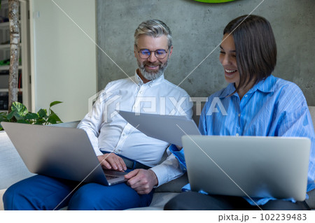 Couple scrutinizing a marriage agreement and looking involved 102239483