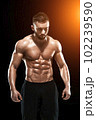 Muscular bodybuilder guy doing posing 102239590