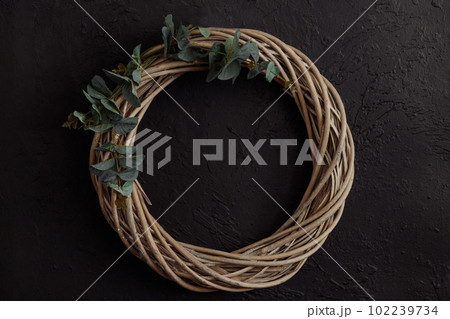 Round vine wreath on a dark background Round vine wreath on a dark background 102239734