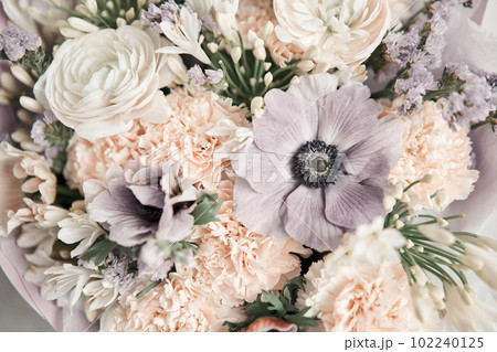Beautiful bouquet of mixed flowers with ranunculus clooney hanoi in woman hand. Floral shop concept . Beautiful fresh cut bouquet. Flowers delivery 102240125