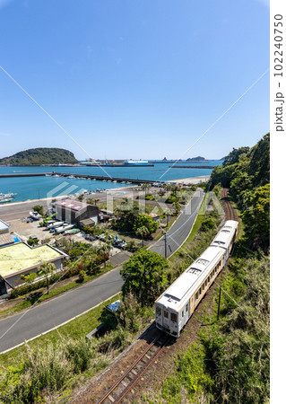 宮崎県日南市油津港を停泊中の船を観ながら港町を走る日南線キハ40 102240750