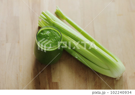 Vegan diet and nutrition, healthy detox, vegetarian concepts drinks. Glass with organic green smoothie celery on a wooden table. Healthy lifestyle concept Vegan diet and nutrition, healthy detox, vegetarian concepts drinks. Glass with organic green smoothie celery on a wooden table. Healthy lifestyle concept 102240934