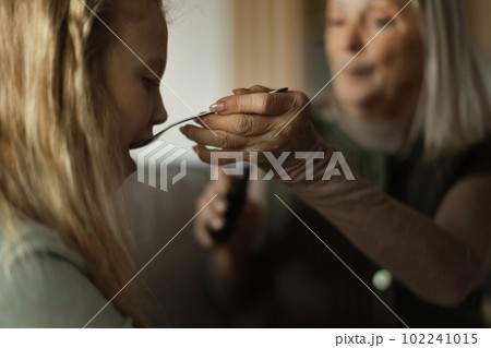 Senior woman taking care of her sick granddaughter. 102241015