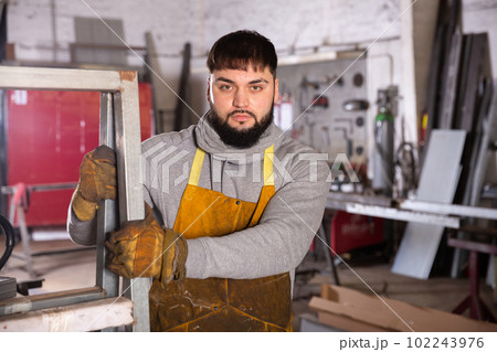 Professional man worker near steel frame during work 102243976