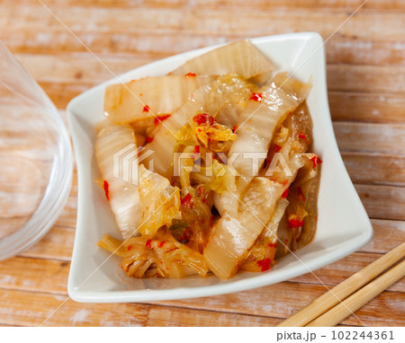 Korean spicy pickled napa cabbage kimchi in salad bowl 102244361