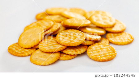 Crispy salted round crackers on white table Crispy salted round crackers on white table 102244548
