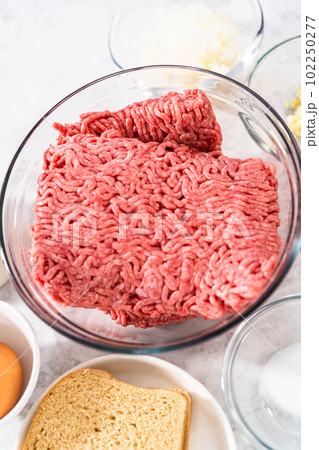 Measured ingredients in glass mixing bowls to make meatloaf. Measured ingredients in glass mixing bowls to make meatloaf. 102250277