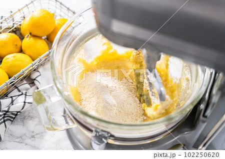 Mixing ingredients into the batter for lemon pound cake. 102250620