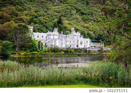 Kylemore Abbey with water reflections in Connemara, County Galway, Ireland, Europe. Benedictine monastery founded 1920 on the grounds of Kylemore Castle. Mainistir na Coille Moire 102255151