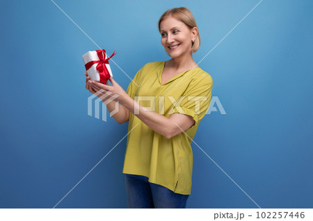 joyful blond middle-aged woman received her birthday present 102257446