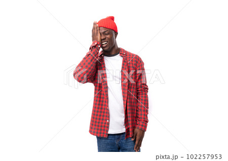 cute 30s dark-skinned american man dressed in a red shirt and hat covered his face with his hand on cute 30s dark-skinned american man dressed in a red shirt and hat covered his face with his hand on 102257953
