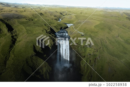 Aerial drone photo of Skogafoss waterfall along Iceland's Ring Road in the summer. Aerial drone photo of Skogafoss waterfall along Iceland's Ring Road in the summer. 102258938