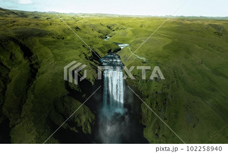 Aerial drone photo of Skogafoss waterfall along Iceland's Ring Road in the summer. Aerial drone photo of Skogafoss waterfall along Iceland's Ring Road in the summer. 102258940