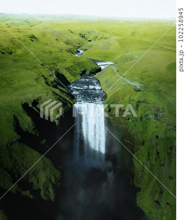 Aerial drone photo of Skogafoss waterfall along Iceland's Ring Road in the summer. Aerial drone photo of Skogafoss waterfall along Iceland's Ring Road in the summer. 102258945