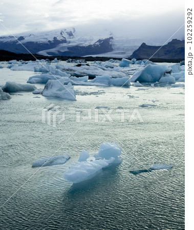 Jokulsarlon Glacier Lagoon in Iceland Vatnajokull National Park. High quality photo. Seals and Whales swimming in glacier bay. Icebergs floating by. Aerial drone image. Jokulsarlon Glacier Lagoon in Iceland Vatnajokull National Park. High quality photo. Seals and Whales swimming in glacier bay. Icebergs floating by. Aerial drone image. 102259292