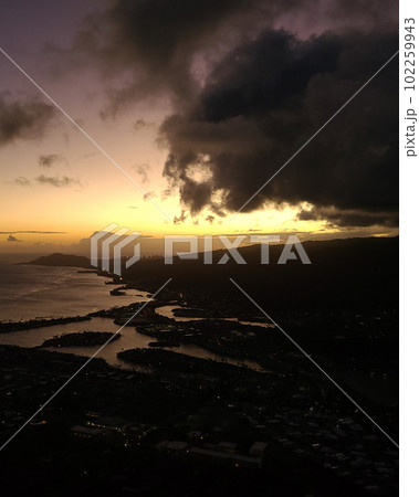 Sunset from top of Koko Head Crater. High quality photo. A railroad track hike up a mountain on Oahu, Hawaii. Sunset from top of Koko Head Crater. High quality photo. A railroad track hike up a mountain on Oahu, Hawaii. 102259943