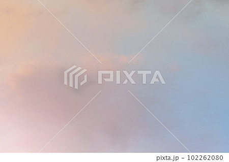 Twilight sky with effect of light in pastel pink, coral, orange, blue tones. Colorful sunset of soft clouds. Background 102262080