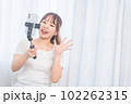 自撮り棒で自撮りする若い女性 102262315
