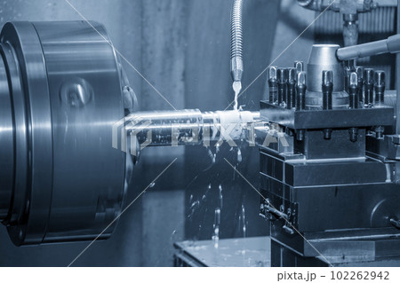 The lathe machine finish cut  metal shaft parts with liquid coolant method. 102262942