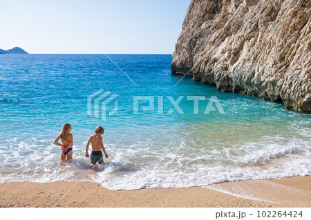 Happy kids looking at turquoise sea water at Kaputas beach 102264424
