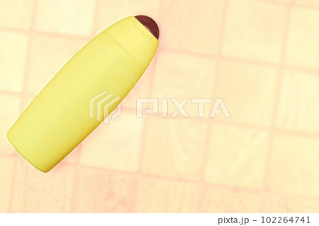 Yellow plastic bottle for detergents and shampoos on a checker yellow background 102264741