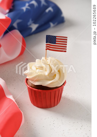 American sweet cupcakes with festive decorations and USA flag. American sweet cupcakes with festive decorations and USA flag. 102265689