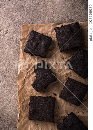 Chocolate brownies on brown background Chocolate brownies on brown background 102266080