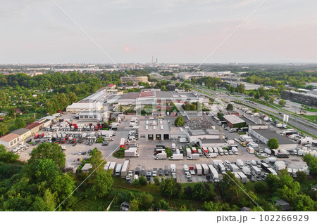 Logistic warehouse in suburban area, aerial view. Industrial center with factory and parked truck on parking lot. 102266929