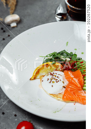Summer healthy fastfood lunch, breakfast with Pancake with red fish, avocado and egg for breakfast. Aesthetic still life, healthy food concept 102267520