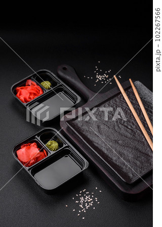 Pickled ginger, soy sauce and wasabi in portioned plastic containers 102267566