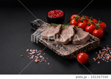 Delicious boiled beef tongue sliced with vegetables and spices 102267580