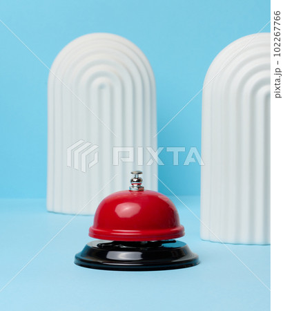 Metallic red bell to call staff on a blue background 102267766