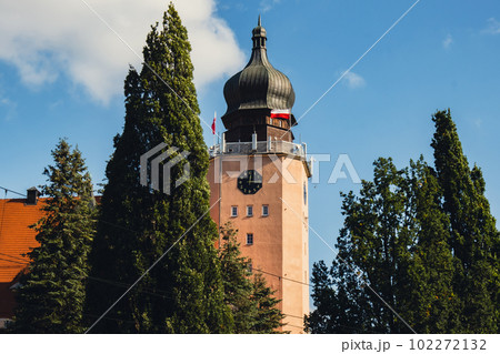 View of the City Government Office of Elblag throught green trees. Polish flags on wind. Travel View of the City Government Office of Elblag throught green trees. Polish flags on wind. Travel 102272132