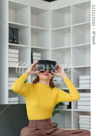 Attractive Asian woman resting comfortable living room and using AR glasses, Relax, Sofa, Lifestyle, Virtual Reality Headset 102273172