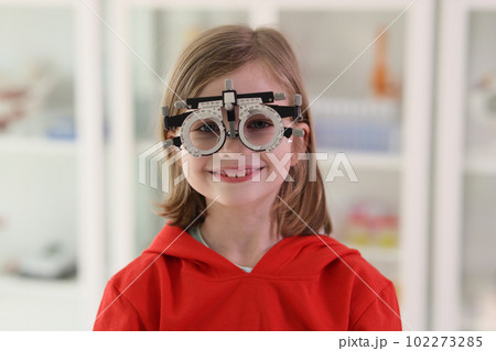 Little girl in ophthalmology goggles for eyesight correction Little girl in ophthalmology goggles for eyesight correction 102273285