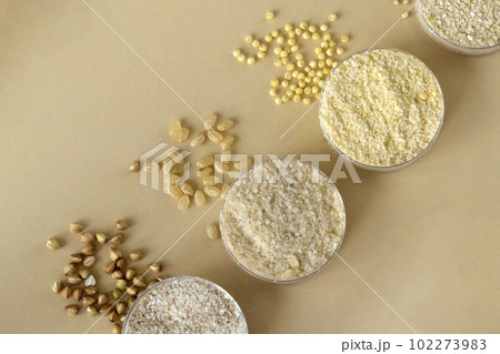 Three types of gluten-free flour on a beige background of millet, rice and buckwheat 102273983