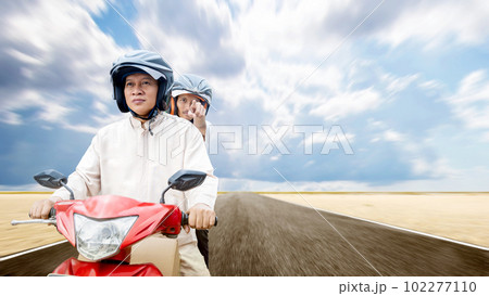 Asian Muslim family carrying a box on a motorcycle going mudik 102277110