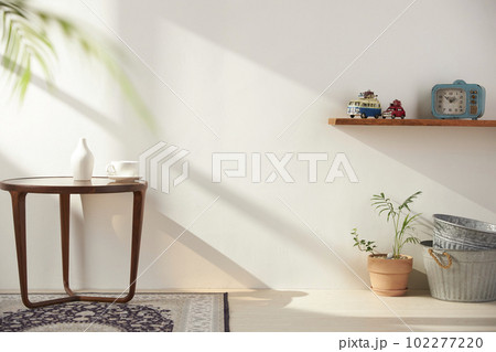 Vases and objects on the table in a warm room with sunlight coming in 102277220