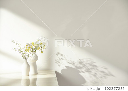 Vases and objects on the table in a warm room with sunlight coming in 102277283