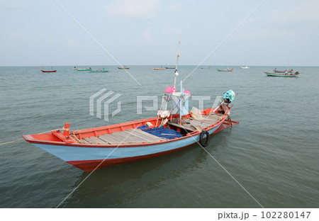 Colorful fishing boat floating on the sea. 102280147