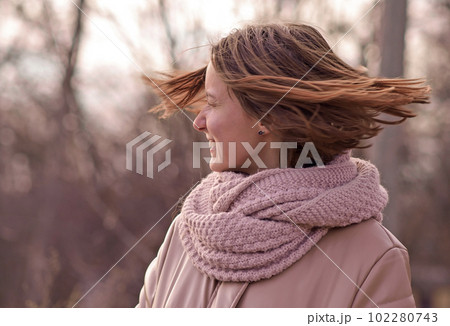 candid attractive young smiling woman walking in autumn park, happy mood, fashion style trend, pink jacket, waving brown hair candid attractive young smiling woman walking in autumn park, happy mood, fashion style trend, pink jacket, waving brown hair 102280743