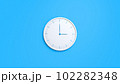 Clock on wall. White wall clock isolated on blue background.  102282348