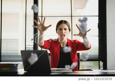 Annoyed caucasian female manager throwing crumpled papers, feeling furious, frustrated, stressed and upset Annoyed caucasian female manager throwing crumpled papers, feeling furious, frustrated, stressed and upset 102283050