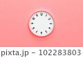 Clock face on pink background. 102283803
