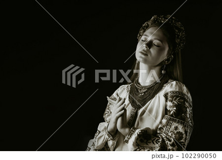 Charming woman in traditional ukrainian blouse on black background. Ukraine 102290050