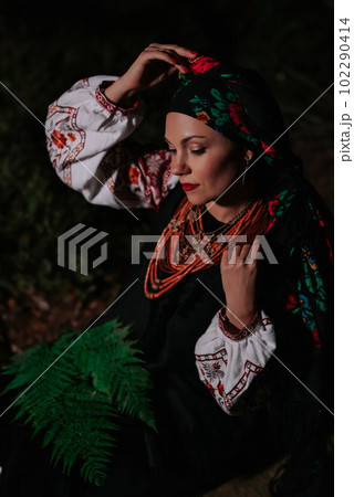 Portrait of ukrainian woman with fern at night in Carpathian mountains forest. Portrait of ukrainian woman with fern at night in Carpathian mountains forest. 102290414