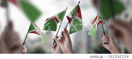 A group of people holding small flags of the Burundi in their hands 102292524