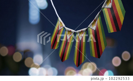 A garland of Zimbabwe national flags on an abstract blurred background 102292533